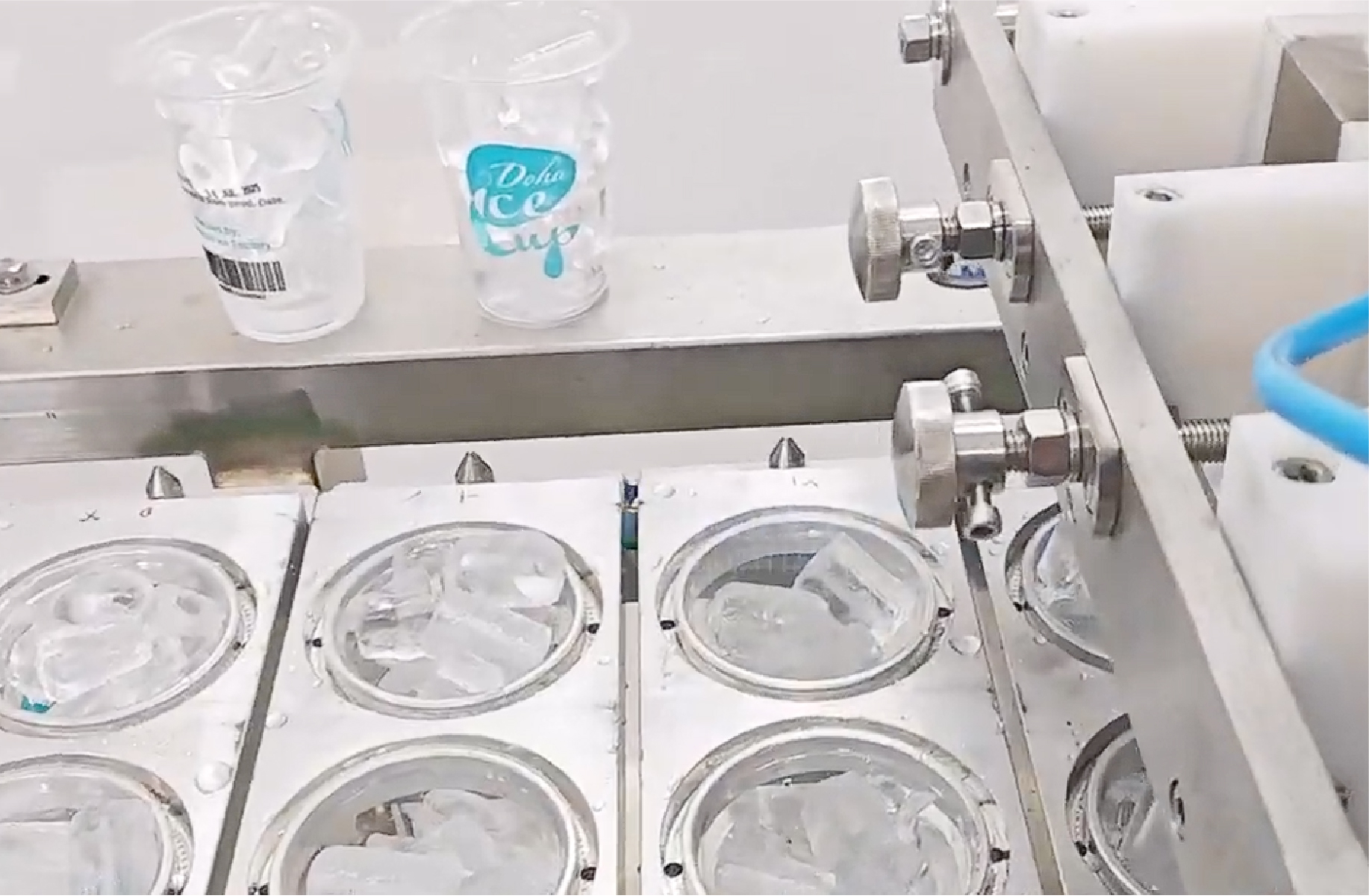 Two lines ice cube cup filling and  sealing machine with cup washing in Qatar